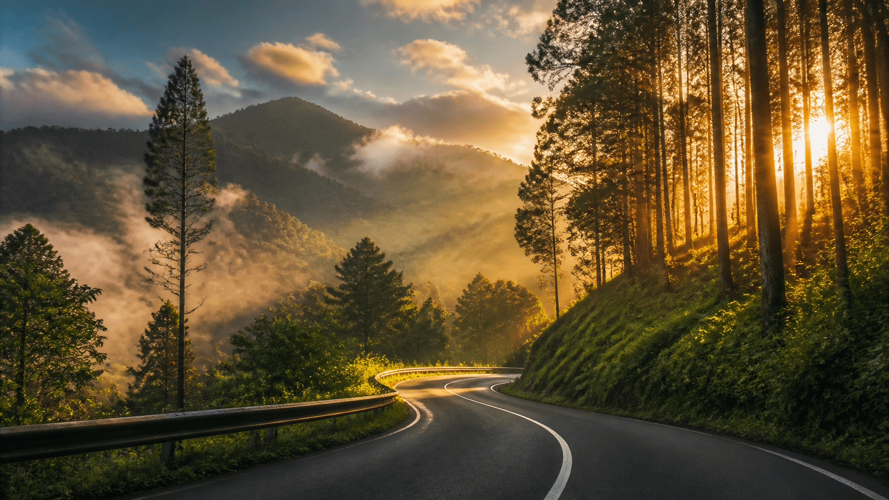 A scenic winding asphalt road leading up to lush green Baturraden hills in Purwokerto, dramatic morn